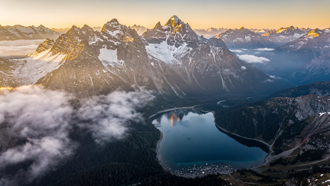 Cinematic aerial shot of mountain landscape at sunrise